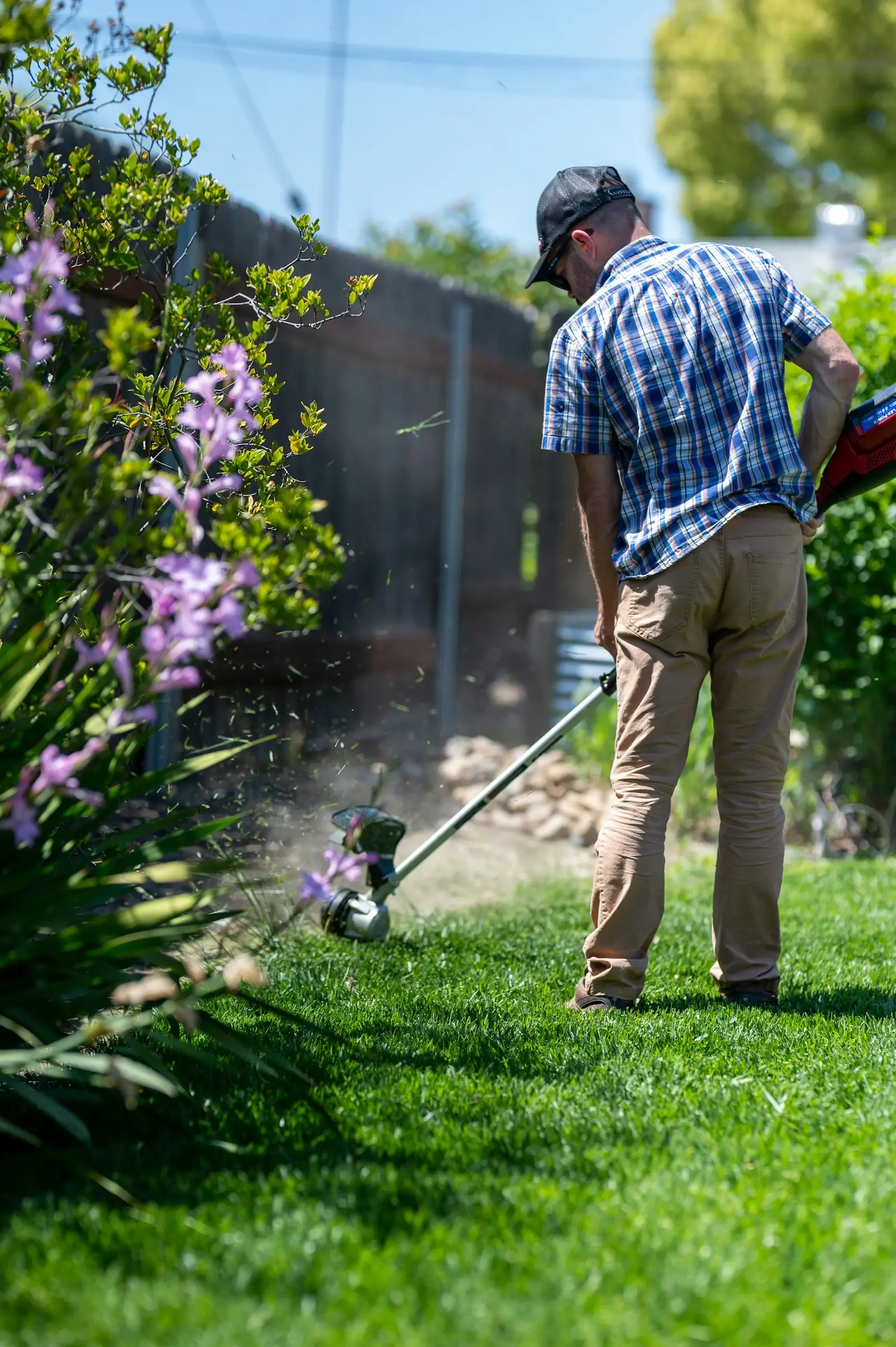 Crew member trimming a lawn edge